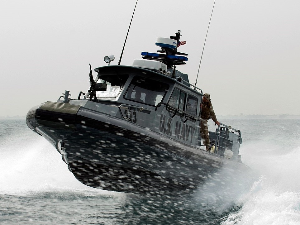 1200px-US_Navy_090210-N-9671T-144_A_port_security_boat_patrols_the_waters_near_Kuwait_Naval_Base